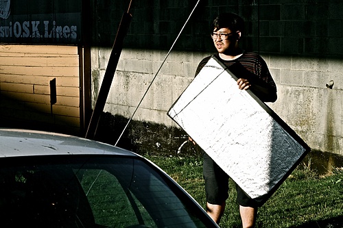 Our DOP, Mike Kam, bouncing sunlight in a scene.
